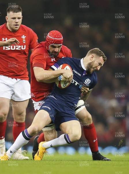 030218 - Wales v Scotland, NatWest 6 Nations - Byron McGuigan of Scotland is held by Cory Hill of Wales
