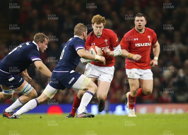 030218 - Wales v Scotland, NatWest 6 Nations - Rhys Patchell of Wales takes on John Barclay of Scotland