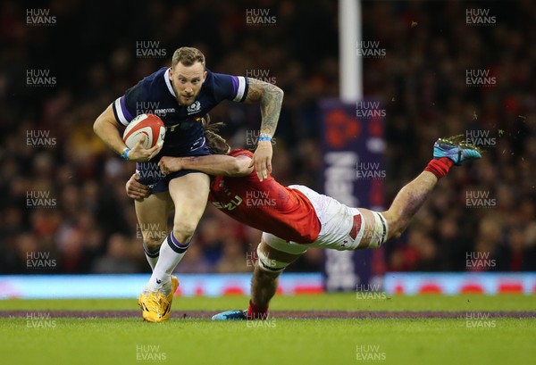 030218 - Wales v Scotland, NatWest 6 Nations - Byron McGuigan of Scotland is tackled by Josh Navidi of Wales