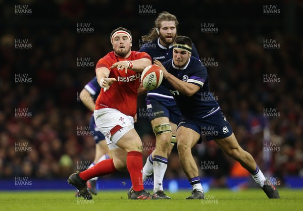 030218 - Wales v Scotland, NatWest 6 Nations - Wyn Jones of Wales feeds the ball out as Stuart McInally of Scotland tackles