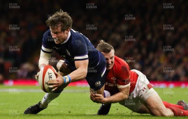 030218 - Wales v Scotland, NatWest 6 Nations - Pete Horne of Scotland is tackled by Hadleigh Parkes of Wales