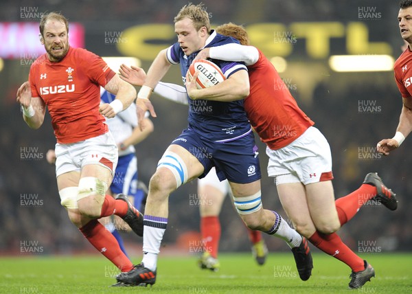 030218 - Wales v Scotland - NatWest 6 Nations - Jonny Gray of Scotland is tackled by Rhys Patchell of Wales 