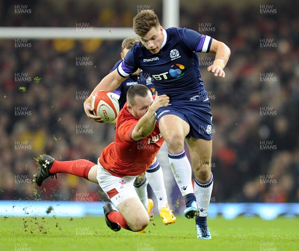 030218 - Wales v Scotland - NatWest 6 Nations - Huw Jones of Scotland is tackled by Ken Owens of Wales  