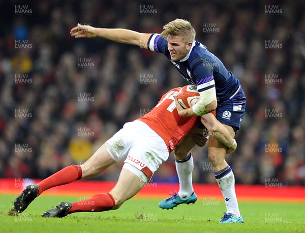 030218 - Wales v Scotland - NatWest 6 Nations - Chris Harris of Scotland is tackled by Josh Adams of Wales 