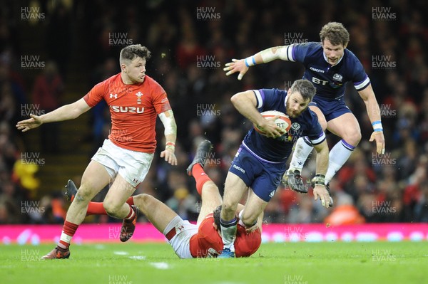 030218 - Wales v Scotland - NatWest 6 Nations - Tommy Seymour of Scotland is tackled by Owen Watkin of Wales 