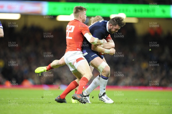 030218 - Wales v Scotland - NatWest 6 Nations - Ryan Wilson of Scotland is tackled by Gareth Anscombe of Wales 