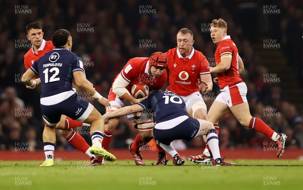 030224 - Wales v Scotland - Guinness 6 Nations 2024 - James Botham of Wales is tackled by Finn Russell of Scotland 