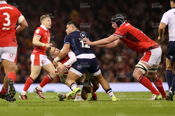 030224 - Wales v Scotland - Guinness 6 Nations 2024 - Cameron Winnett of Wales is tackled by Sione Tuipulotu of Scotland 