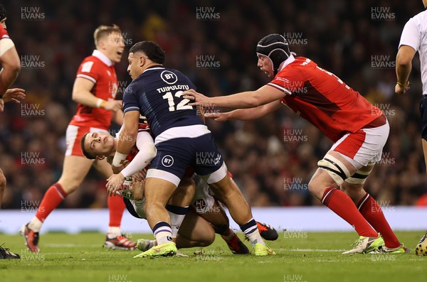 030224 - Wales v Scotland - Guinness 6 Nations 2024 - Cameron Winnett of Wales is tackled by Sione Tuipulotu of Scotland 