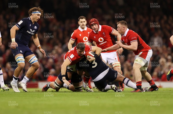 030224 - Wales v Scotland - Guinness 6 Nations 2024 - Elliot Dee of Wales is tackled by Zander Fagerson of Scotland 