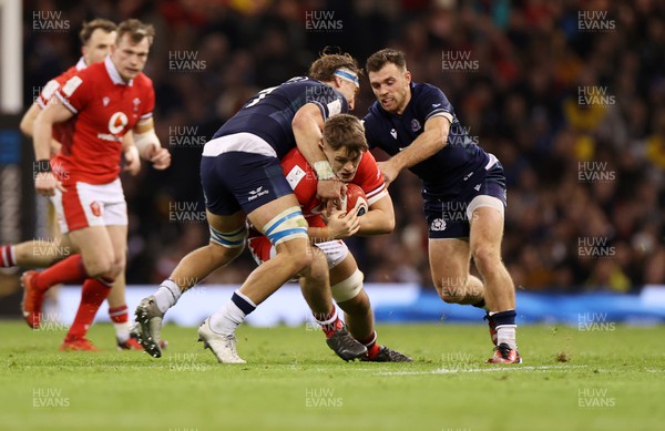 030224 - Wales v Scotland - Guinness 6 Nations 2024 - Alex Mann of Wales is tackled by Jamie Ritchie of Scotland on his first cap