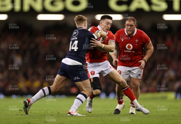 030224 - Wales v Scotland - Guinness 6 Nations 2024 - Josh Adams of Wales is tackled by Kyle Steyn of Scotland 