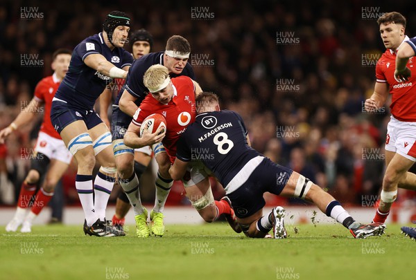 030224 - Wales v Scotland - Guinness 6 Nations 2024 - Aaron Wainwright of Wales is tackled by Matt Fagerson of Scotland 