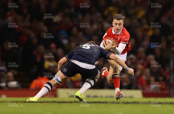 030224 - Wales v Scotland - Guinness 6 Nations 2024 - Cameron Winnett of Wales is tackled by Scott Cummings of Scotland 
