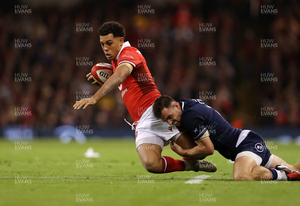 030224 - Wales v Scotland - Guinness 6 Nations 2024 - Rio Dyer of Wales is tackled by Kyle Steyn of Scotland 