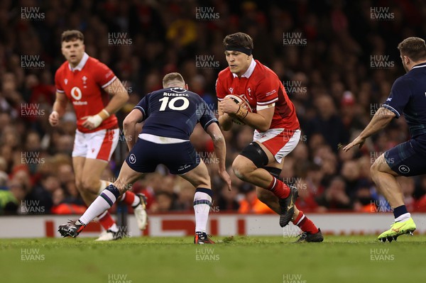 030224 - Wales v Scotland - Guinness 6 Nations 2024 - Teddy Williams of Wales is tackled by Finn Russell of Scotland 