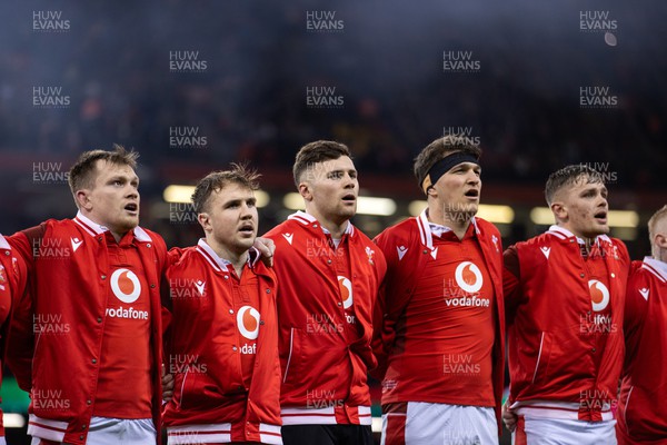 030224 - Wales v Scotland - Guinness 6 Nations 2024 - Nick Tompkins, Ioan Lloyd, Mason Grady, Teddy Williams and Alex Mann of Wales during the anthem