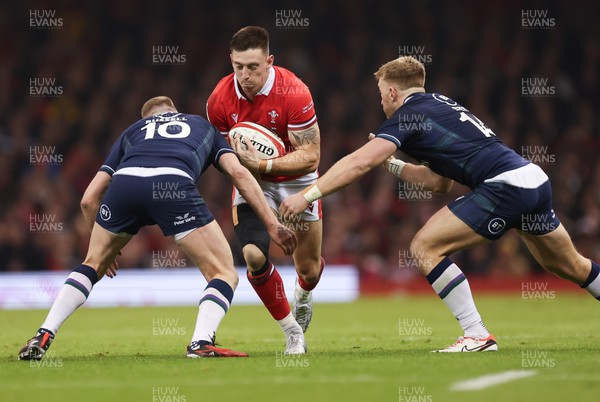 030224 - Wales v Scotland, Guinness Six Nations 2024 - Josh Adams of Wales is tackled by Finn Russell of Scotland and Kyle Steyn of Scotland