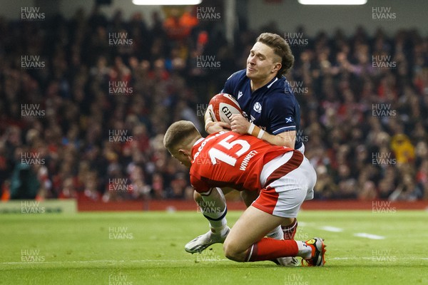 030224 - Wales v Scotland - Guinness Six Nations - Kyle Rowe of Scotland is tackled by Cameron Winnett of Wales