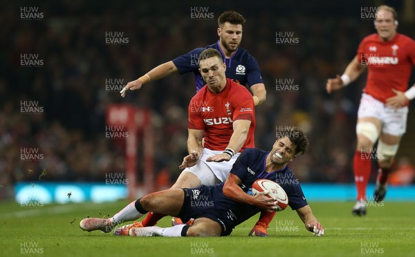 031118 - Wales v Scotland - Under Armour Series - Adam Hastings of Scotland is tackled by George North of Wales