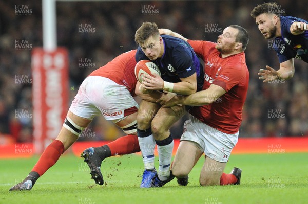 031118 - Wales v Scotland - Under Armour Series - Huw Jones of Scotland  is tackled by Cory Hill of Wales and Ken Owens of Wales 