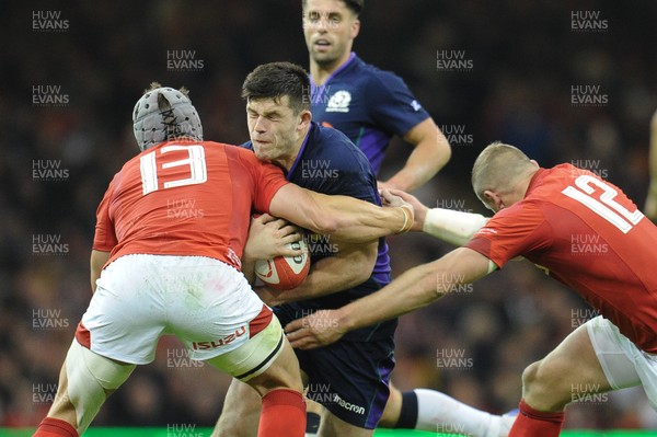 031118 - Wales v Scotland - Under Armour Series - Blair Kinghorn of Scotland is tackled by Jonathan Davies of Wales and Hadleigh Parkes of Wales 