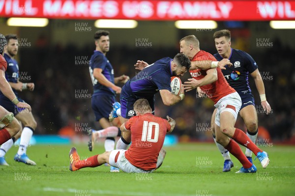 031118 - Wales v Scotland - Under Armour Series - Alex Dunbar of Scotland is tackled by Gareth Anscombe and Hadleigh Parkes of Wales 
