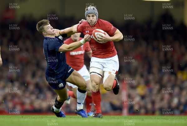 031118 - Wales v Scotland - Doddle Weir Cup -  Jonathan Davies of Wales holds off Huw Jones of Scotland 