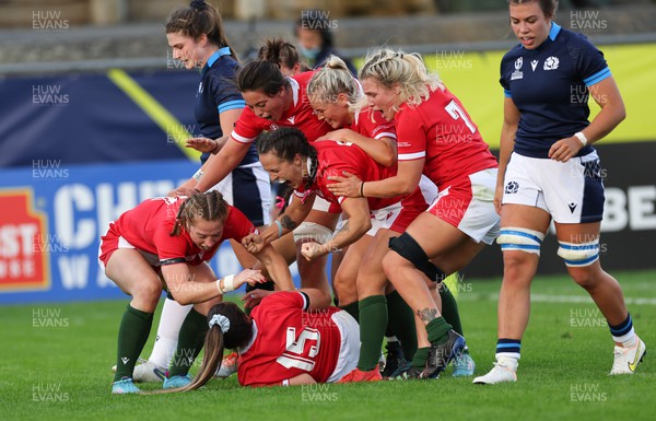 091022 - Wales v Scotland, Women’s Rugby World Cup 2021 Pool A - Kayleigh Powell of Wales is congratulated by team mates after she races in to score try