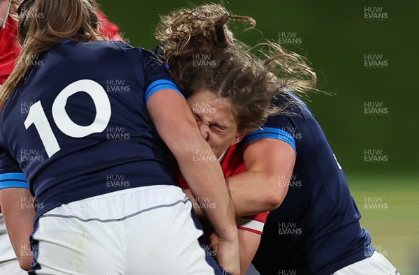 091022 - Wales v Scotland, Women’s Rugby World Cup 2021 Pool A - Natalia John of Wales is tackled by Helen Nelson of Scotland and Sarah Bonar of Scotland