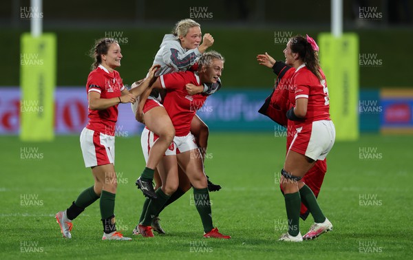 091022 - Wales v Scotland, Women’s Rugby World Cup 2021 Pool A - Alisha Butchers of Wales is carried onto the pitch at the end of the match by Hannah Jones  as Wales celebrate the win