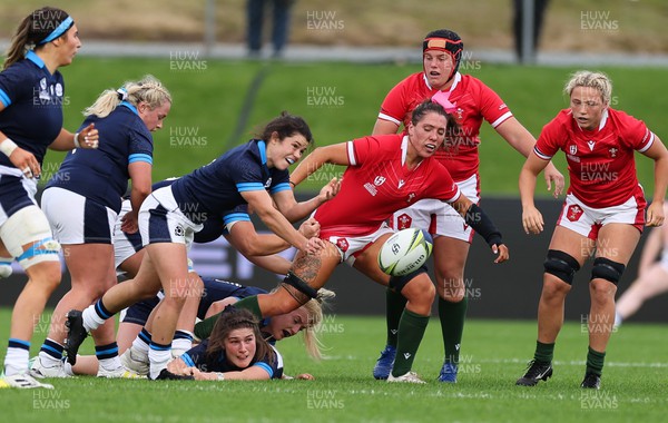 091022 - Wales v Scotland, Women’s Rugby World Cup 2021 Pool A - Georgia Evans of Wales, Carys Phillips  and Alisha Butchers of Wales look on as Caity Mattinson of Scotland feeds the ball out
