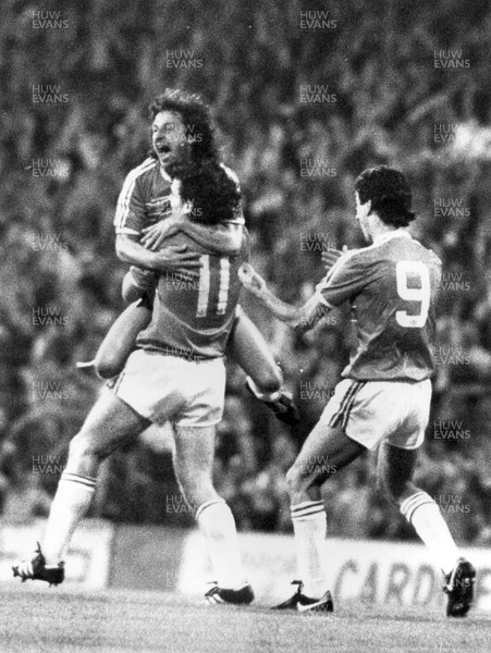 100985 - Wales v Scotland - World Cup Qualifier - Mark Hughes (11) celebrates his goal with Mickey Thomas (lt) and Ian Rush (rt)