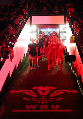 110426 - Wales v Scotland, Guinness Women’s 6 Nations - Wales captain Kate Williams and mascot Nell Rolfe make their way to the pitch for the start of the match