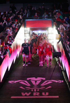 110426 - Wales v Scotland, Guinness Women’s 6 Nations - Wales captain Kate Williams and mascot Nell Rolfe make their way to the pitch for the start of the match