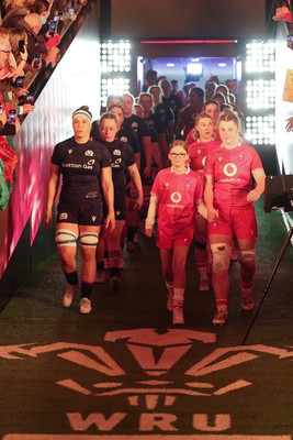 110426 - Wales v Scotland, Guinness Women’s 6 Nations - Wales captain Kate Williams and mascot Nell Rolfe make their way to the pitch for the start of the match