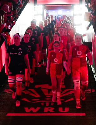 110426 - Wales v Scotland, Guinness Women’s 6 Nations - Wales captain Kate Williams and mascot Nell Rolfe make their way to the pitch for the start of the match