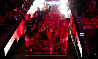 110426 - Wales v Scotland, Guinness Women’s 6 Nations - Wales captain Kate Williams and mascot Nell Rolfe make their way to the pitch for the start of the match