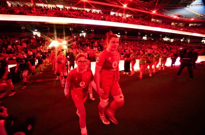 110426 - Wales v Scotland, Guinness Women’s 6 Nations - Wales captain Kate Williams and mascot Nell Rolfe make their way to the pitch for the start of the match