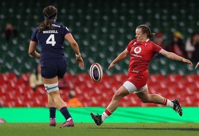 110426 - Wales v Scotland, Guinness Women’s 6 Nations - Lleucu George of Wales kicks past Emma Wassell of Scotland 