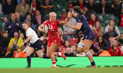 110426 - Wales v Scotland, Guinness Women’s 6 Nations - Seren Singleton of Wales holds off Emma Wassell of Scotland as she breaks away late into the match