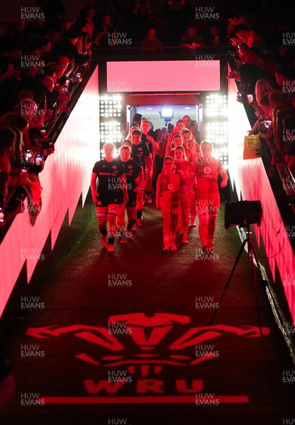 110426 - Wales v Scotland, Guinness Women’s 6 Nations - Wales captain Kate Williams and mascot Nell Rolfe make their way to the pitch for the start of the match