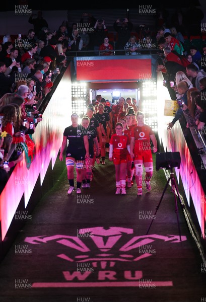 110426 - Wales v Scotland, Guinness Women’s 6 Nations - Wales captain Kate Williams and mascot Nell Rolfe make their way to the pitch for the start of the match