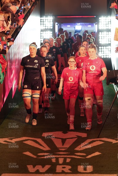 110426 - Wales v Scotland, Guinness Women’s 6 Nations - Wales captain Kate Williams and mascot Nell Rolfe make their way to the pitch for the start of the match