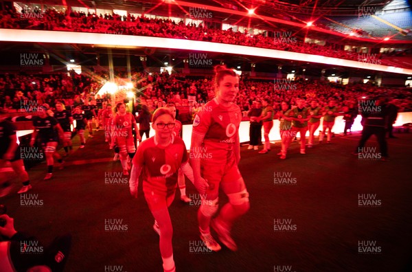110426 - Wales v Scotland, Guinness Women’s 6 Nations - Wales captain Kate Williams and mascot Nell Rolfe make their way to the pitch for the start of the match