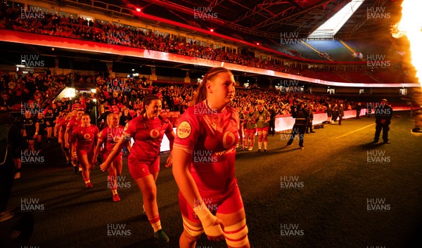 110426 - Wales v Scotland, Guinness Women’s 6 Nations - Wales captain Kate Williams and mascot Nell Rolfe make their way to the pitch for the start of the match