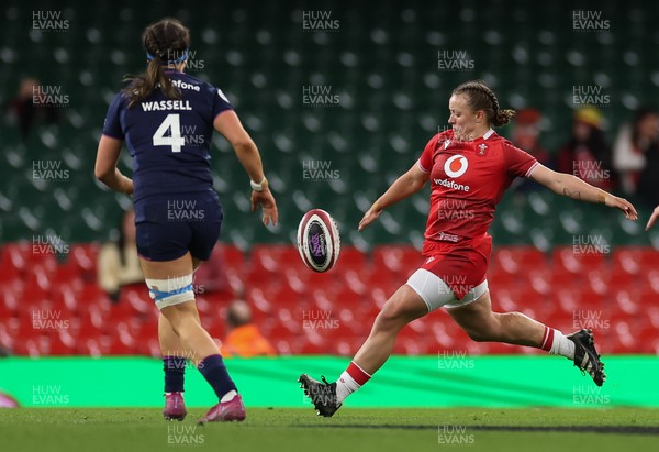 110426 - Wales v Scotland, Guinness Women’s 6 Nations - Lleucu George of Wales kicks past Emma Wassell of Scotland 