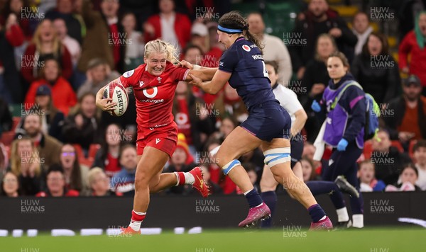 110426 - Wales v Scotland, Guinness Women’s 6 Nations - Seren Singleton of Wales holds off Emma Wassell of Scotland as she breaks away late into the match