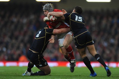 120212 - Wales v Scotland - RBS Six Nations 2012 -Jonathan Davies of Wales is tackled by Ross Ford and Rory Lamont of Scotland