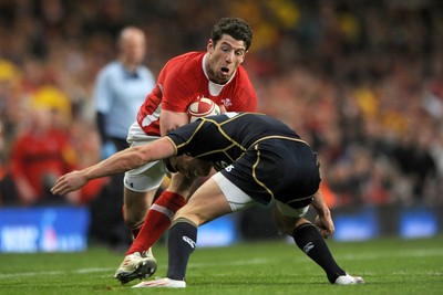 120212 - Wales v Scotland - RBS Six Nations 2012 -Alex Cuthbert of Wales is tackled by Lee Jones of Scotland